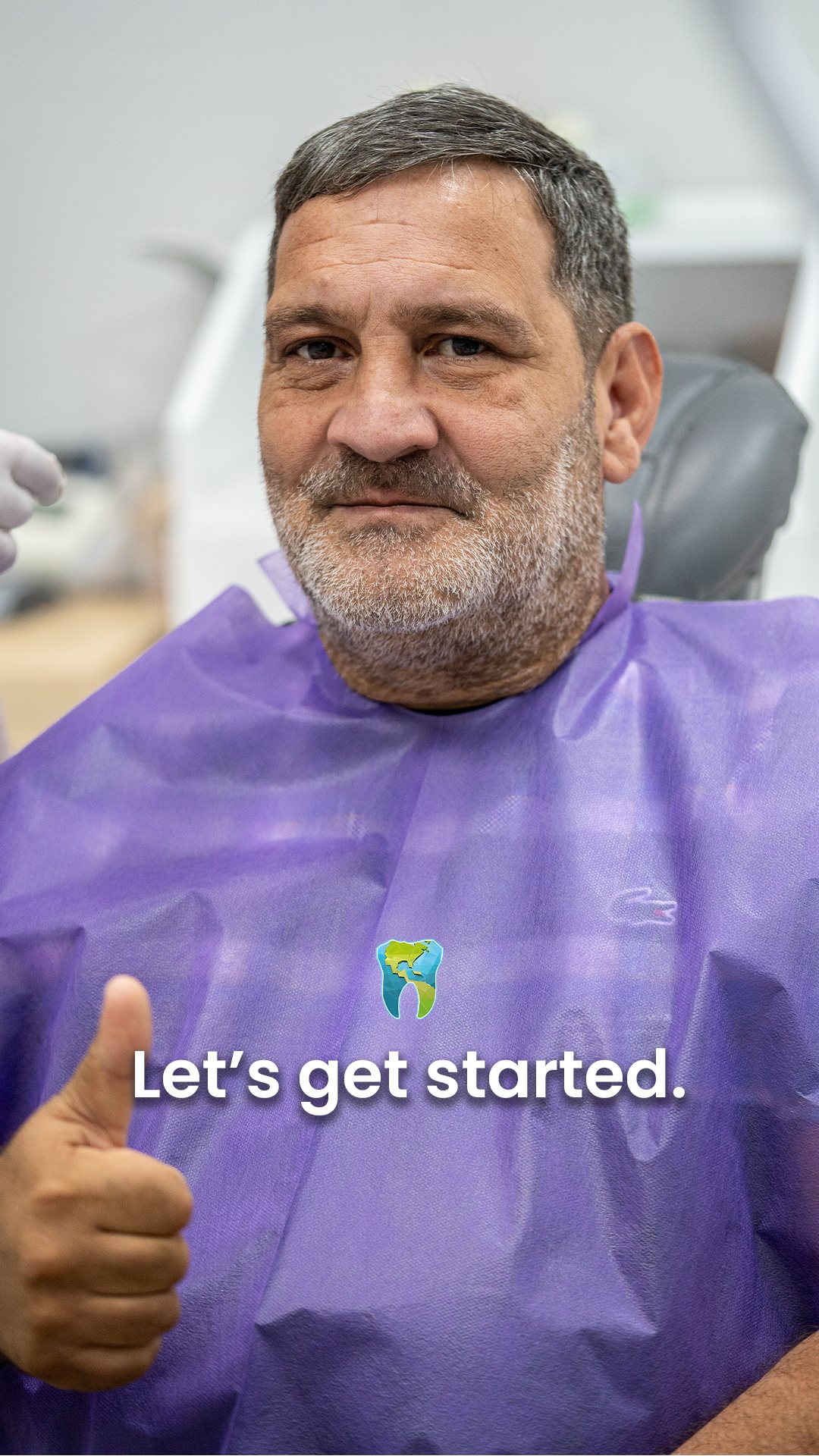 Patient in the dental chair giving a thumbs up